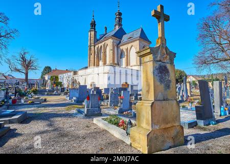 The vintage stone cross on cemetery in front of the old chapel of Sedlec Ossuary, Kutna Hora, Czech Republic Stock Photo