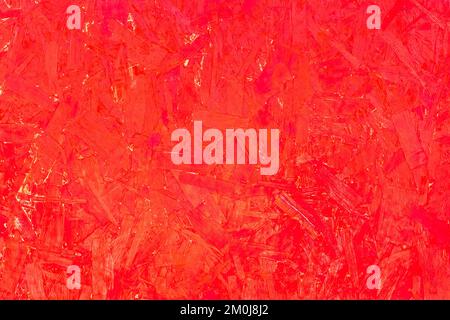 Red paint pressed wood texture, chipboard surface pattern background osb particleboard. Stock Photo