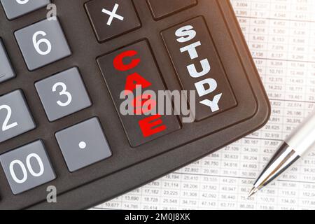 Business and finance. On the table is a report, a pen and a calculator, on the big key of which is written - CASE STUDY Stock Photo