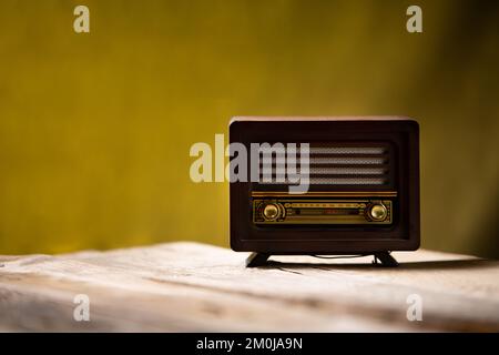 Old brown radio, retro radio on wooden table. Perspective vintage radio. Stock Photo
