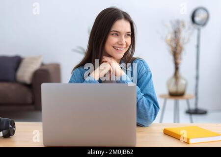 Online learning successful young caucasian woman using laptop while working remotely at home, distance education Stock Photo