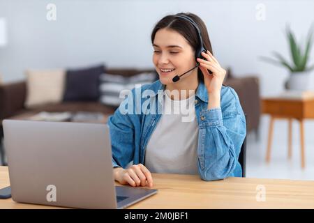Portrait of happy caucasian female employee customer support services in headset Stock Photo