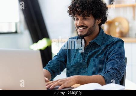 man freelancer using laptop computer typing working online coworking or modern office Distance learning online education Stock Photo