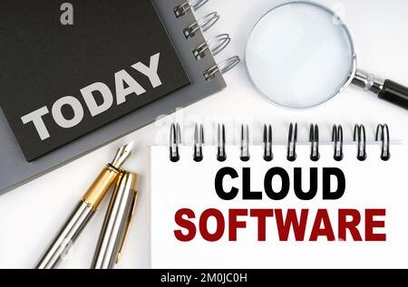 Business and finance concept. On the table are a pen and notebooks with the words - Today and Cloud Software Stock Photo