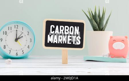 CARBON MARKETS. text on white sticker on wood background. Stock Photo