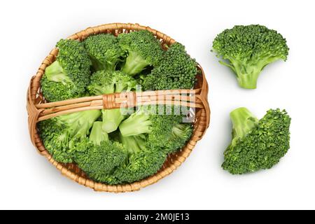 fresh broccoli in wicker basket isolated on white background close-up with full depth of field. Top view. Flat lay. Stock Photo