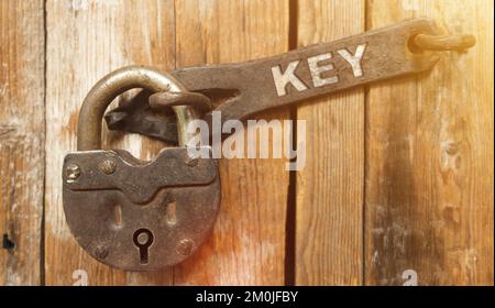 Security concept. There is a lock on the door on the metal part of which it is written - KEY Stock Photo