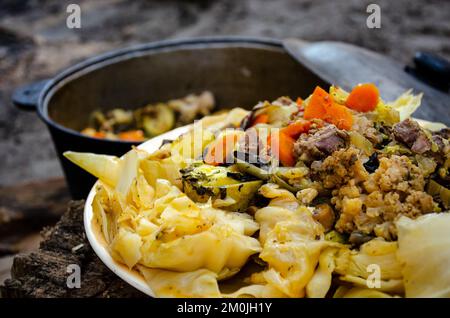 Dimlama on a platter. Uzbek cuisine. Vegetables cooked in their own juice in a cauldron over a fire. Cooking in nature. Healthy food Stock Photo