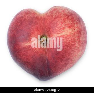 Heart-shaped donut flat peach isolated on white top view. Fruitarianism and love to fruits concept. Stock Photo