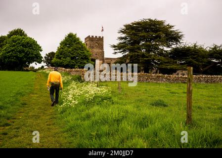 St Michaels and All Angels Church along The Warden's Way public path  in Guiting Power, Cotswold District, England. Stock Photo