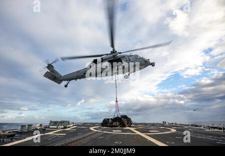 Ionian Sea. 22nd Nov, 2022. An MH-60S Sea Hawk helicopter, attached to Helicopter Sea Combat Squadron (HSC) 5, delivers cargo from the Lewis and Clark-class dry cargo and ammunition ship USNS William McLean (T-AKE 12) to the flight deck of the Arleigh Burke-class guided-missile destroyer USS Roosevelt (DDG 80) during a vertical replenishment, November. 22, 2022. Roosevelt is on a scheduled deployment in the U.S. Naval Forces Europe area of operations, employed by U.S. Sixth Fleet to defend U.S., allied and partner interests. (Credit Image: © U.S. Navy/ZUMA Press Wire Service/ZUMAPRESS.co Stock Photo