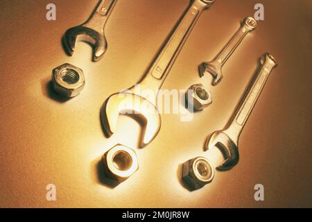 Spanners and Nuts on Warm Background Stock Photo