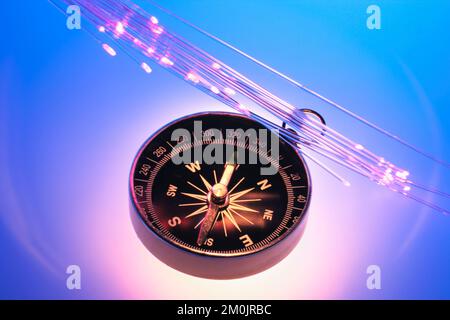 Compass with Optic Fibres on Blue Background Stock Photo