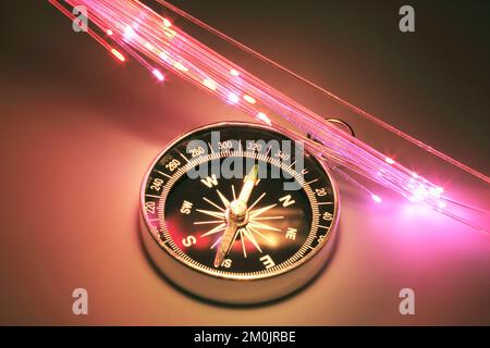 Compass with Optic Fibres on Warm Background Stock Photo