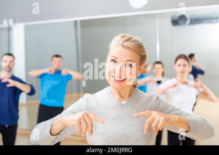 Mature woman practicing vigorous dance Stock Photo