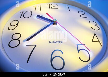 Close Up of Clock on Blue Background Stock Photo