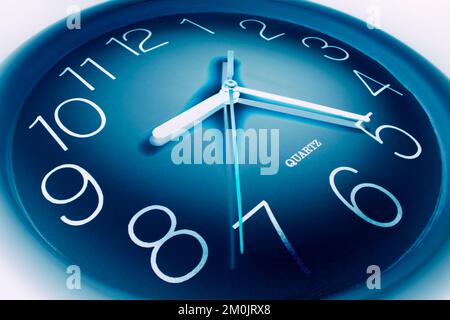 Close Up of Clock on Blue Background Stock Photo