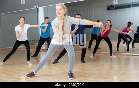 Mature woman practicing vigorous dance Stock Photo