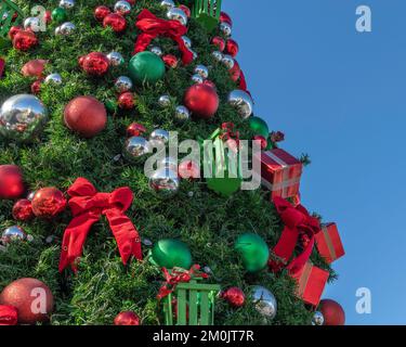 Close up of a decorated Christmas tree with green, silver, and red balls. Stock Photo