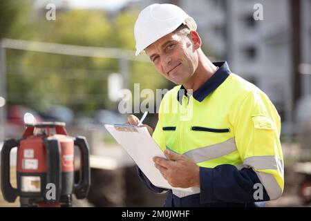 architect checking insulation during house construction Stock Photo