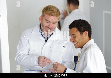a house painter and an electrician laughing Stock Photo