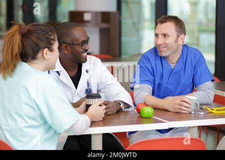 group of doctors relaxing during lunch break Stock Photo