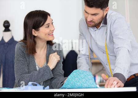 seamstresses carrying tape measure and working in a textile factory Stock Photo
