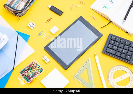 Black tablet with office supplies Stock Photo