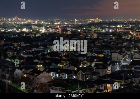 Aerial view of sprawling residential neighborhood near city at night Stock Photo