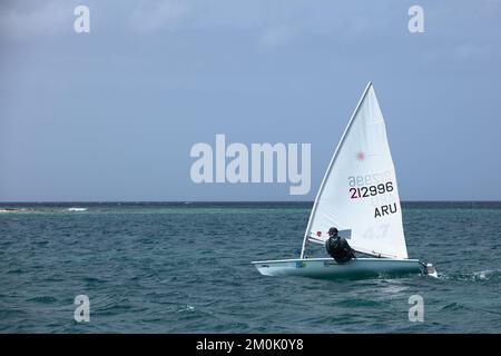 ORANJESTAD, ARUBA - MARCH 27, 2022: Small laser boat sailing along the coast at Surfside beach in Oranjestad on the Caribbean island of Aruba Stock Photo