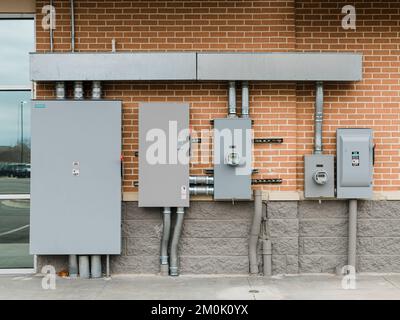 Row of commercial or industrial electrical boxes on the wall of a row of businesses in Pike Road Alabama, USA. Stock Photo
