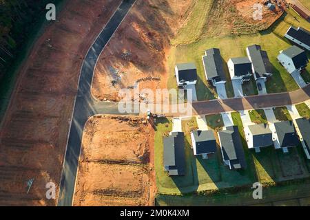Aerial view of real estate development with tightly located family houses under construction in Carolinas suburban area. Concept of growing american Stock Photo