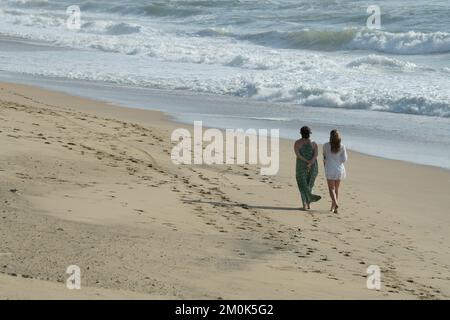 Family relationship, two active adult women walking on beach, Durban, South Africa, seaside vacation, enjoying company, mother, daughter, outdoor Stock Photo