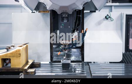 Modern industry high precision CNC machining center measuring workpiece. Industrial metalworking manufacture. Stock Photo