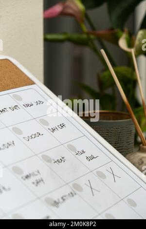 Monthly PLANNER filled with appointments and plans for next month. Busy month schedule. Magnetic board with the days of the month. Place to enter important matters schedule. Concept for business planning. Whiteboard Planner magnetic monthly template. Interior of freelancer workplace  Stock Photo