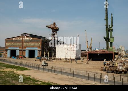 Gdansk, Poland - July 19 2022: Industrial building at the Gdansk Shipyard, former Lenin Shipyard, prefabrication workshop and heavy cranes large Polish shipyard. Cranes at historical shipyard in Gdansk headquarters of Solidarity Polska Stock Photo