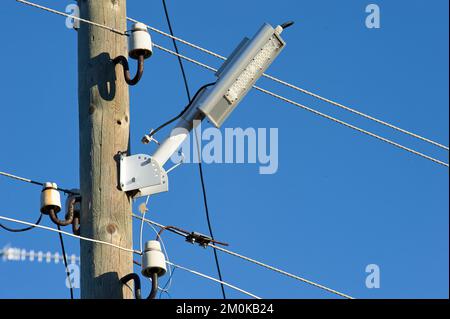 The LED street light is attached to a wooden pole Stock Photo