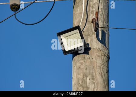 The LED street light is attached to a wooden pole Stock Photo