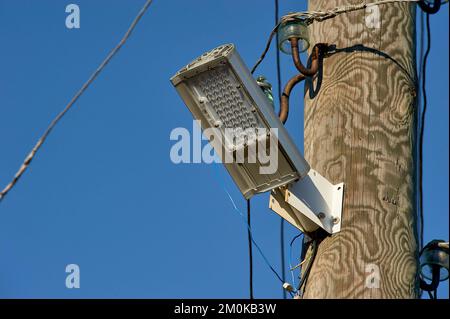 The LED street light is attached to a wooden pole Stock Photo