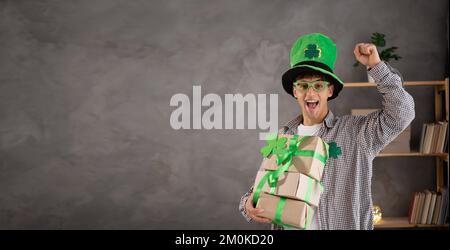 St. patrick's day gifts, holiday sale, happy home buyer with delivery boxes. Banner. Copy space Stock Photo