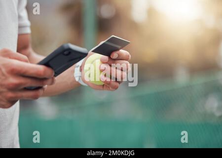 Closeup of unknown mixed race tennis player using cellphone and credit card on court. Hispanic fit athlete paying for sports membership on a phone in Stock Photo