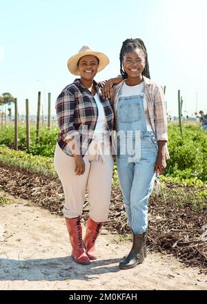 Two colleagues together on a farm. Portrait of happy farmers in the garden. Young women standing on a farm. Smiling women working on a sustainable Stock Photo