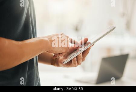 Closeup of a businessman using a digital tablet. Hands of architect working online on a wireless device. Hands of businessman scrolling online apps on Stock Photo