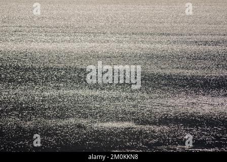 Sea view against the sun with sparkling water on the Northumberland coast Stock Photo