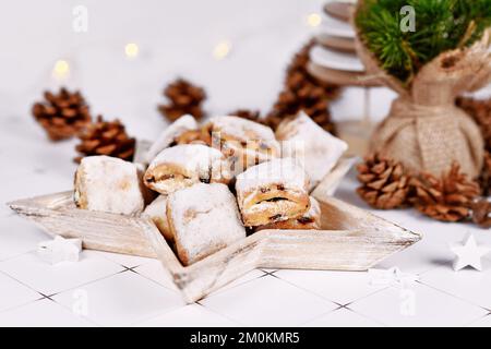 German Stollen cake pieces, a fruit bread with nuts, spices, and dried fruits with powdered sugar traditionally served during Christmas time Stock Photo