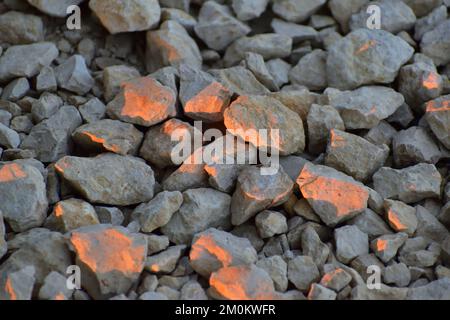 Sunrise Golden Hour light painting rocks with natural light pink orange and red glow on surfaces facing the rising sun Stock Photo