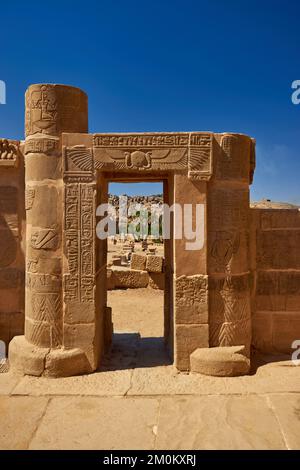 A vertical shot of the Philae temple complex against the blue sky in Egypt Stock Photo