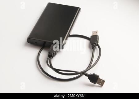 black portable USB disc drive in metal case with USB wire isolated on white background Stock Photo
