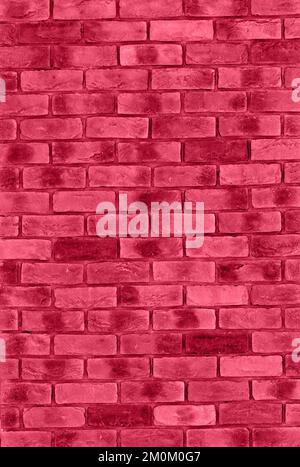 Viva Magenta color of the year 2023 pink red brick wall, vertical background, copy space, building exterior, wall texture Stock Photo