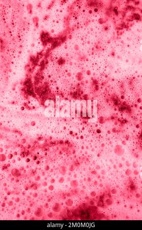 Viva Magenta color of the year 2023 Vertical background of cappuccino foam close-up Abstract, foamy texture, copy space Stock Photo